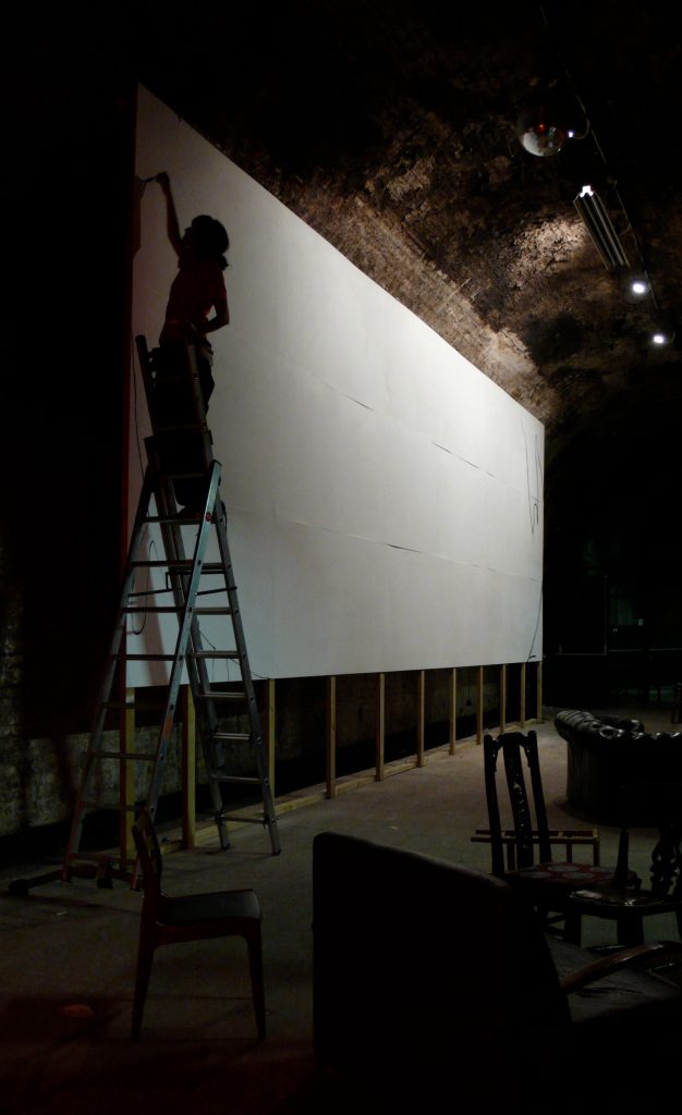 Cristina Guitian starting to paint on a 12 x 6 metres long white canvas