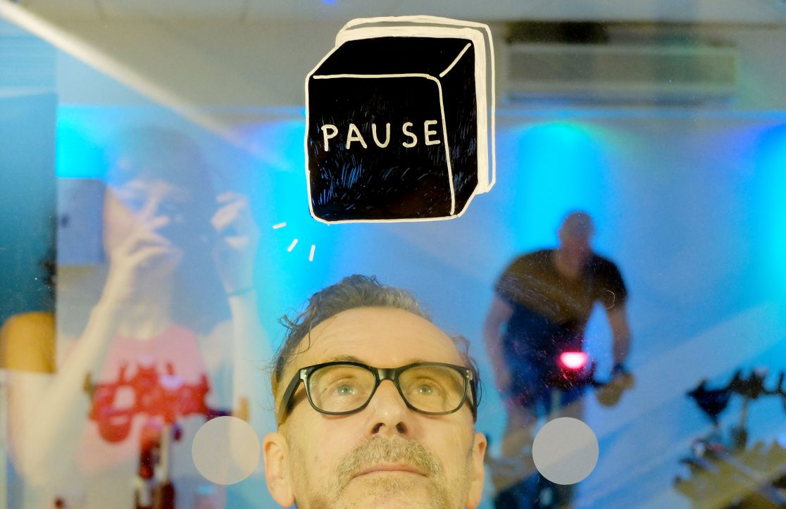 YMCA Graffiti - Pause button painted on glass in the gym