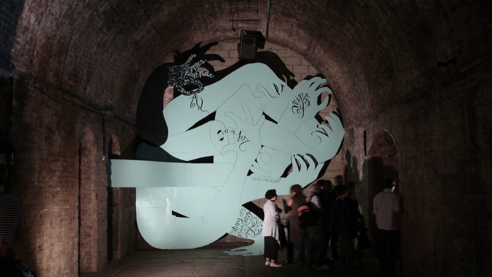 Knotted Arms with people walking by, a 11.50 x 5 m installation created in the massive Shunt Vaults