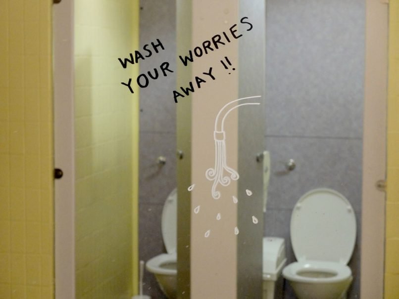 YMCA Graffiti - Wash your worries away painted on mirror in the gym
