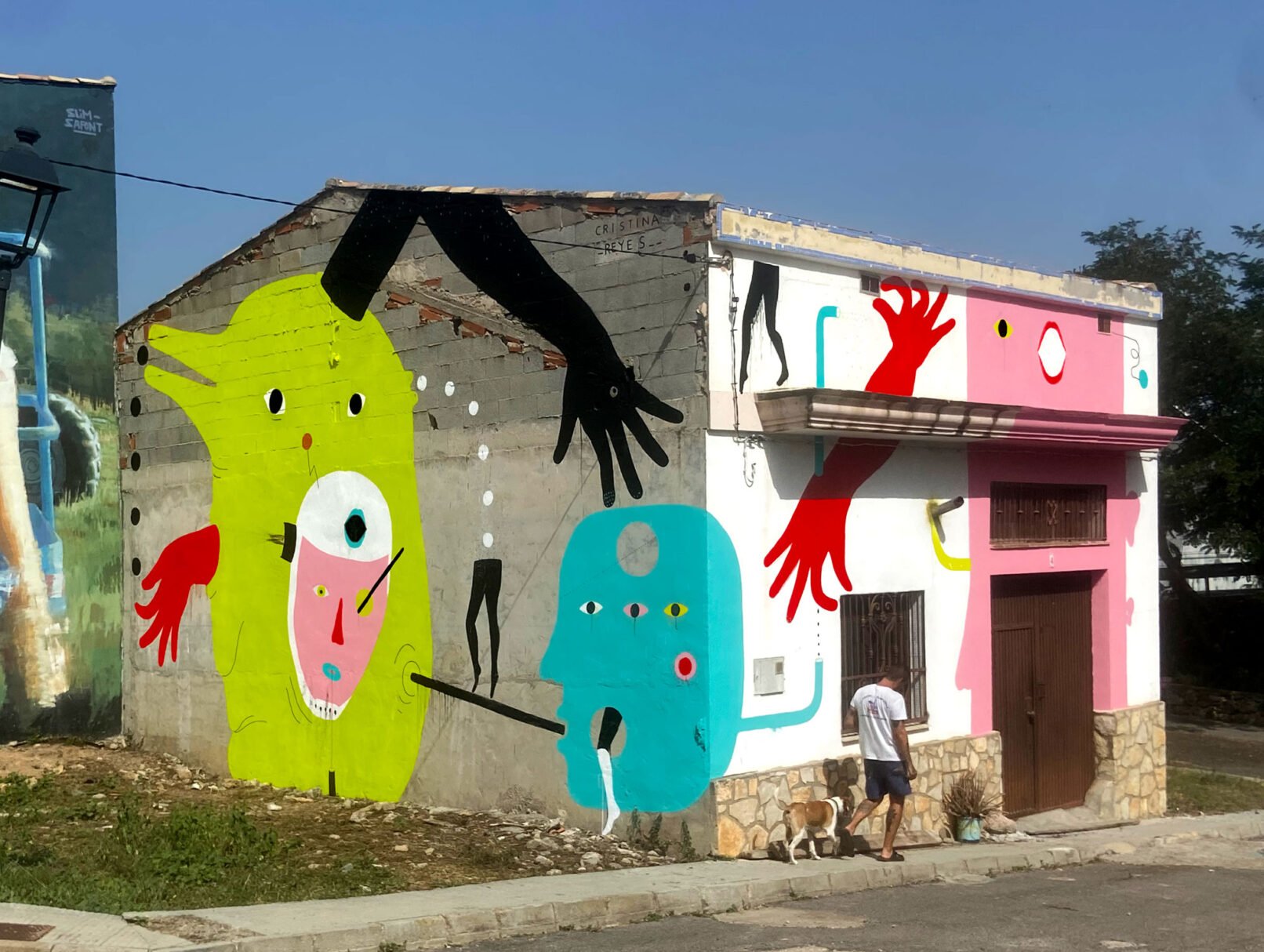 ‘Los Sin Nombre’, 2023, acrylic on concrete and brick wall, 6 x 17.4 m, front